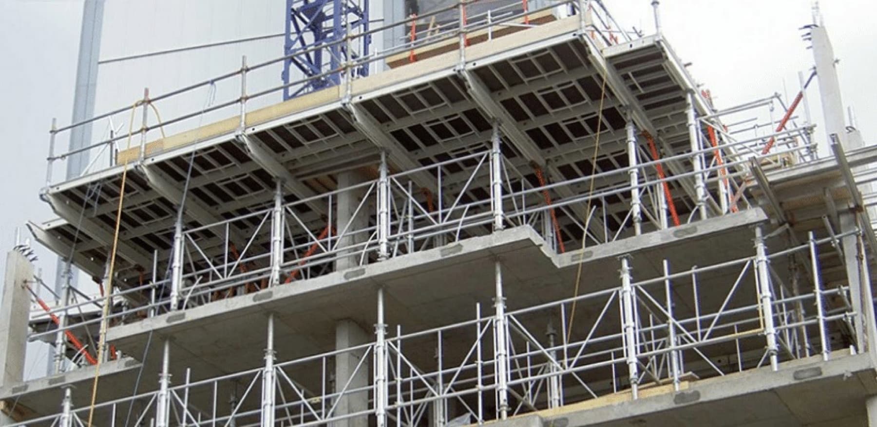 Multi-level commercial building under construction with formwork decks and propping to the levels below